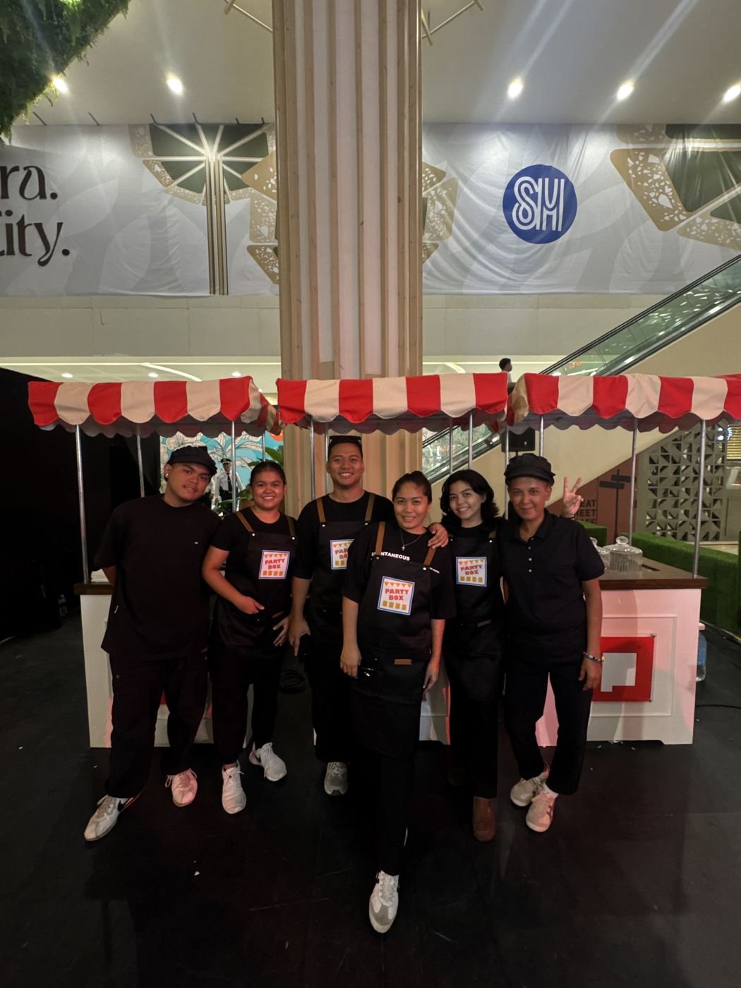 The PartyBox crew in branded aprons at an SM mall event