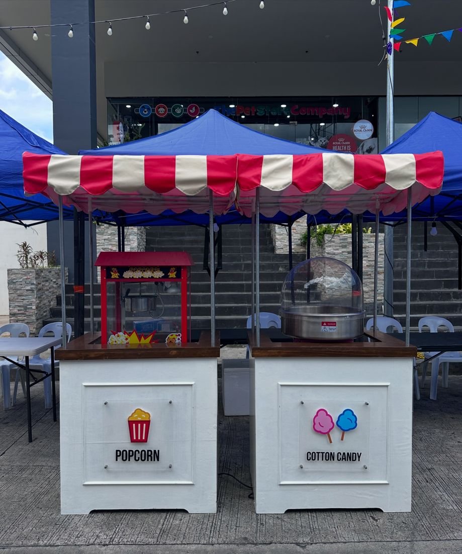 Popcorn and cotton candy carts at an outdoor market